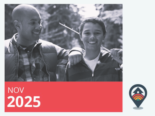 A father and son standing next to each other and smiling at the camera