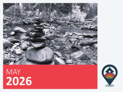 Black and white image of a stack of rocks in a riverbed