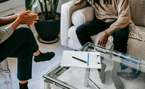 two people talking with a clipboard on the table